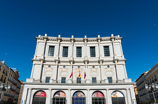 Madrid, Spain - June 7, 2014: Main facade of the Teatro Real (Madrid's Opera House) as seen from the Plaza de Oriente in central Madrid on a clear Spring day.