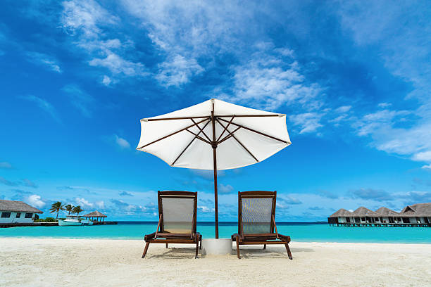 istock Beach lounger and umbrella on sand beach. 509252821