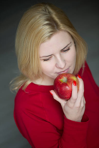 istock Beautiful girl eating apple 509253529