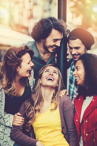 Group of mixed race people outdoors in the city, having fun.