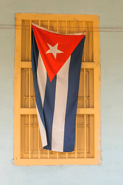 cuban flag at window in pinar-del-rio cuba