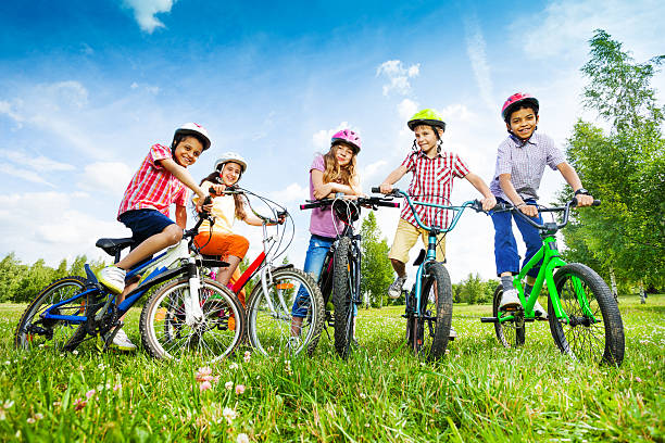 istock Children in colorful helmets hold their bikes 509255191