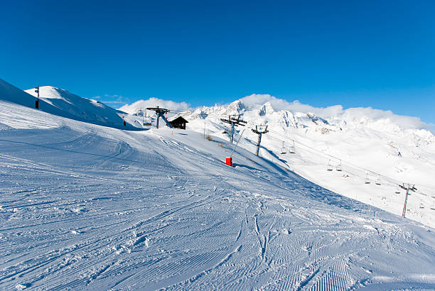 istock Chair lift and snowy mountains 509255429