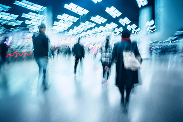 istock motion blurred travellers walking in modern airport hallway 509256960