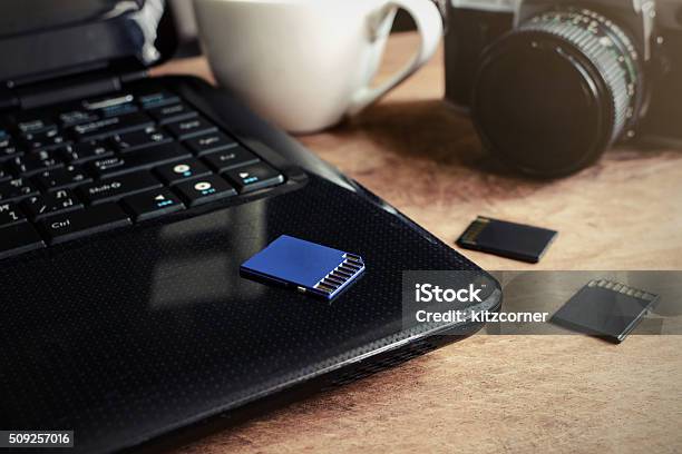 Laptop Camera And A Cup Of Coffee On Wooden Desk Stock Photo - Download Image Now - Memory Card, Camera - Photographic Equipment, Coffee - Drink