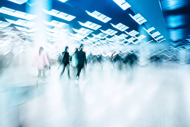 istock motion blurred travellers walking in modern airport hallway 509257106