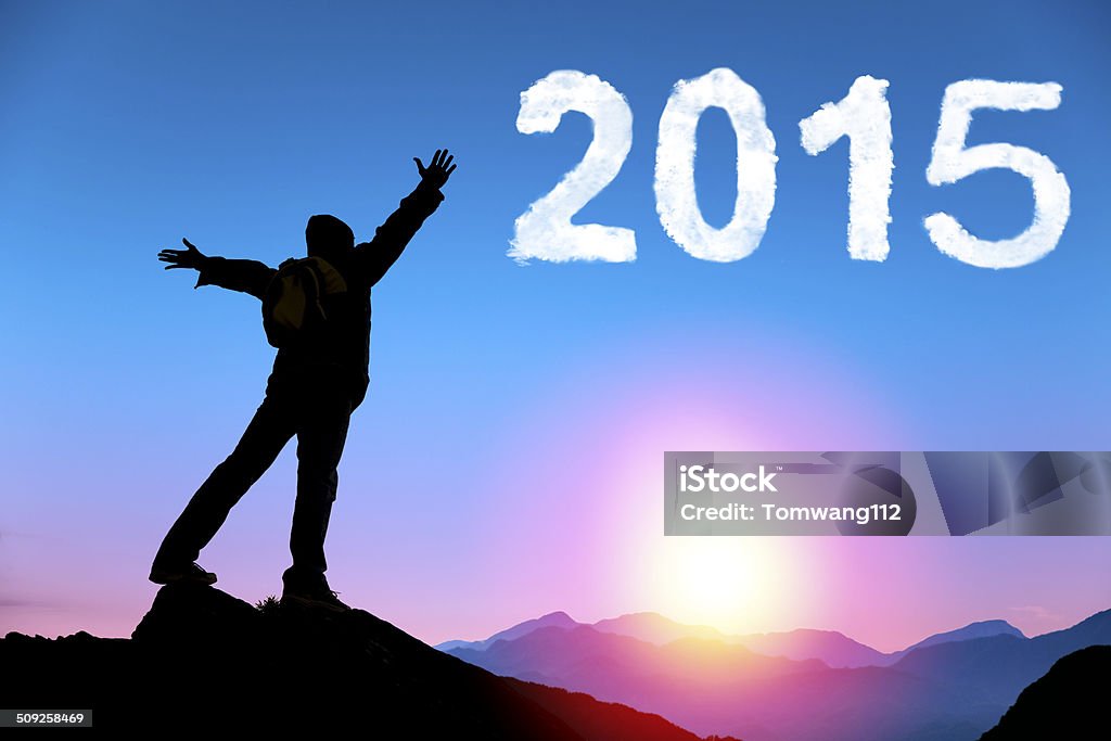 happy new year 2015. young man standing on the mountain happy new year 2015.happy young man standing on the top of mountain with sunrise 2015 Stock Photo