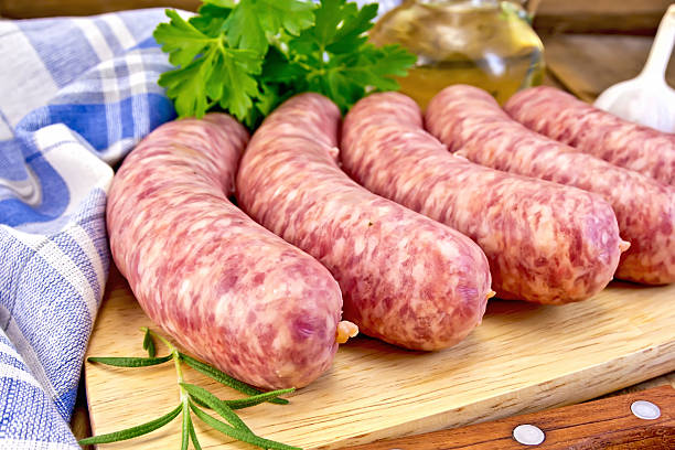 istock Sausages pork with rosemary on board 509273689