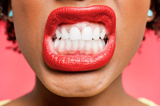 Portrait of an African American woman Detail shot of woman clenching teeth clenching teeth stock pictures, royalty-free photos & images