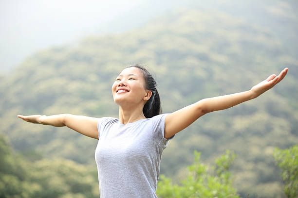 istock cheering hiking woman open arms at mountain peak 509275039