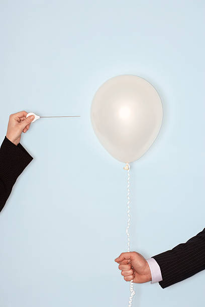 istock Hands With Needle And Balloon Against Blue Background 509278689