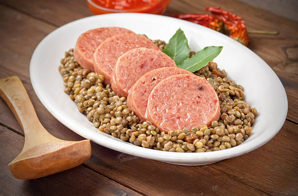 Italian cotechino with lentils Italian cotechino with lentils on christmas table hedgehog mushroom stock pictures, royalty-free photos & images