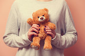 Woman holding teddy bear toy