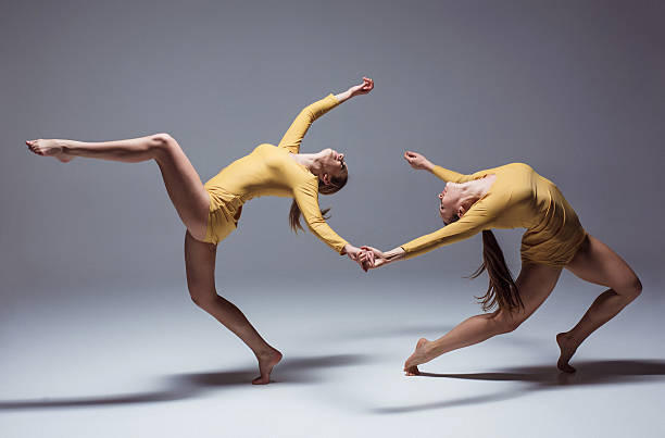 The two modern ballet dancers The two modern ballet dancers dancing on gray background dancing school stock pictures, royalty-free photos & images