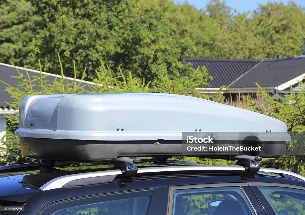 Roof box on car with tree background Box - Container Stock Photo