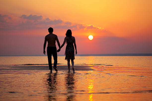 istock Two people in love at sunset 509290053