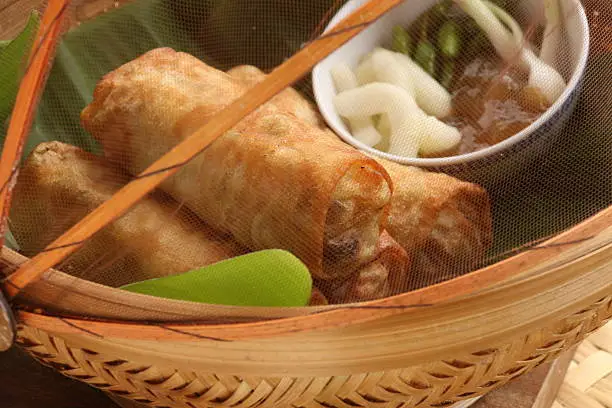 Photo of Loenpia Semarang with Condiments in Bamboo Container