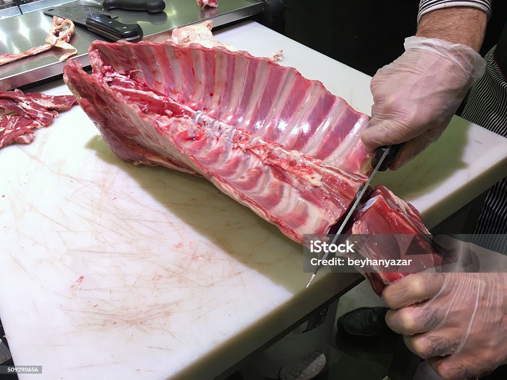 Cutting lamb meat Cutting lamb meat in the kitchen.selective focus. Meat Stock Photo