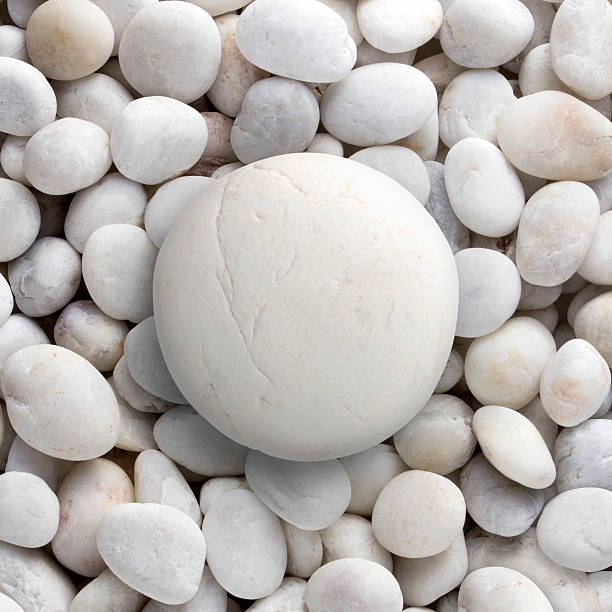 istock Big white rock laid on small round pebble, circle stone 509290835