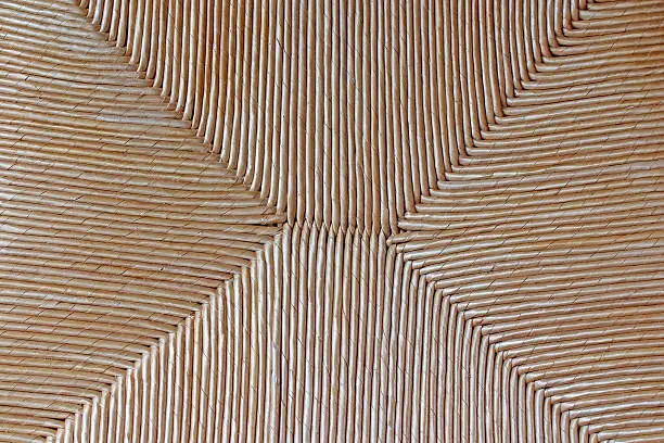 Close up image of beige tan chair thatching seat texture 
