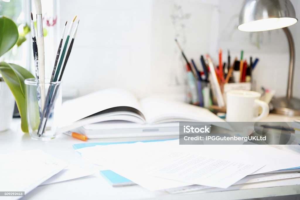 Desk With Books; Papers And Brushes Artist's desk with books; papers and brushes Book Stock Photo