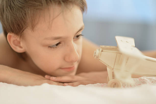 istock boy with a wooden airplane 509292652