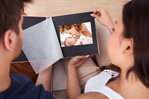 istock Couple Looking Through Photo Album 509292981