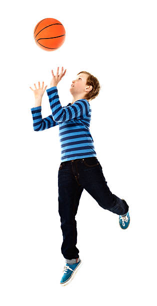 istock Schoolboy basketball player in action, catching ball 509293655
