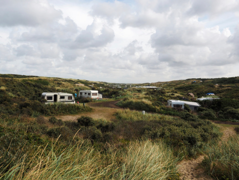 Camping site in the Dunes of De Koog, Texel, Netherlands. Texel is one of the wadden islands of the Netherlands. The wadden islands are on the list of the Unesco heritage. The island is a populair vacaation destination. There are a lot of campings on the island.