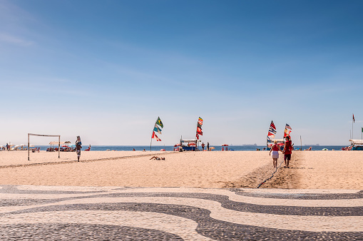 Rio de Janeiro, Brazil - December 21, 2012: Tourists and local people enjoying life at the beach at Copacabana Beach, Rio de Janeiro.