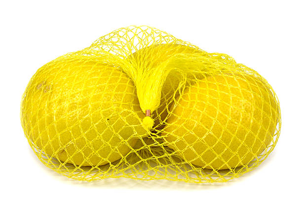 istock lemons in a net isolated against a white background 509294898