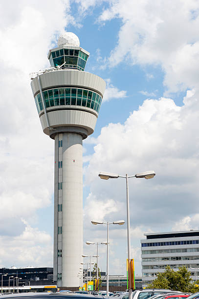 Airport command tower against cloudy sky stock photo