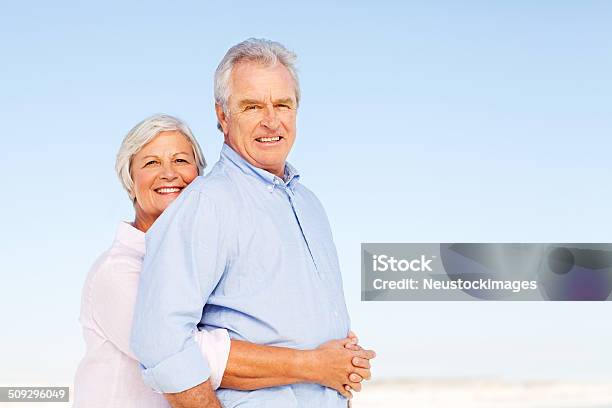 Liebevoll Senior Frau Umarmen Mann Von Hinten Auf Clear Blue Stockfoto und mehr Bilder von 60-64 Jahre