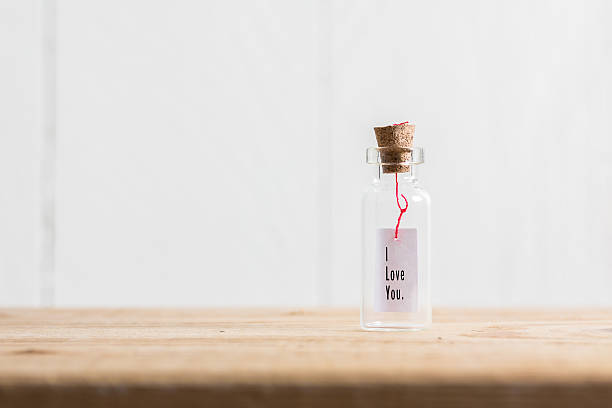 istock Love message in a bottle on wood table 509297466