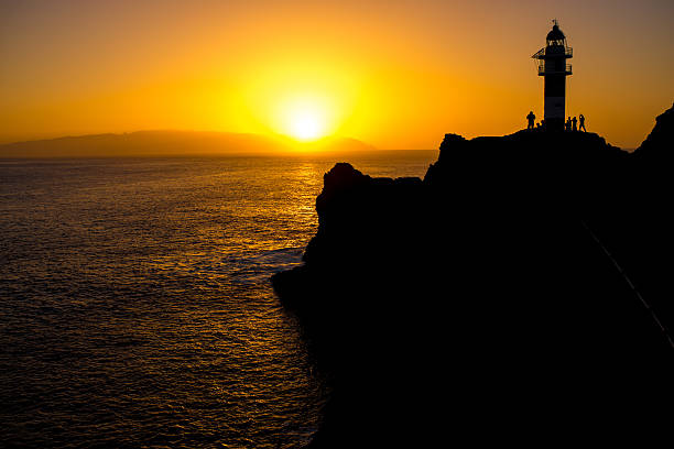istock Rocky coastline with lighthouse on the sunset 509298700