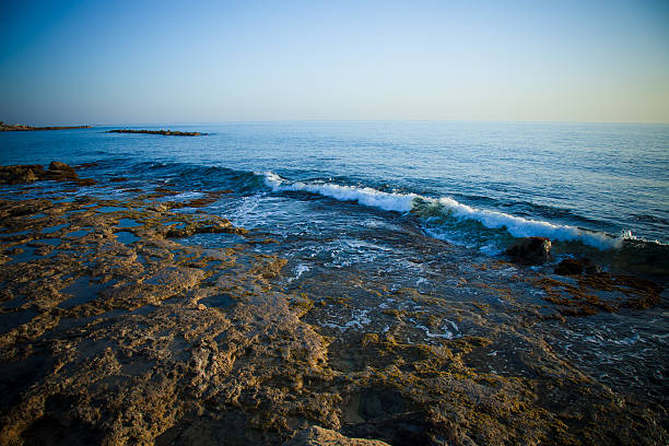 istock Sea waves with foam on the stony shore. Toned 509299142
