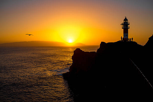 istock Rocky coastline with lighthouse on the sunset 509299272