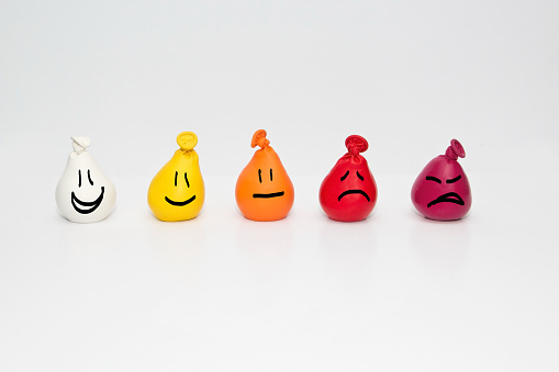 Doodle Smiley faces on small color gradation balloons. Useful at a pediatrician or doctors office. On white background