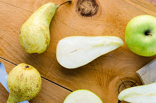 istock Fresh sweet green pears with apples on wooden table 509302518