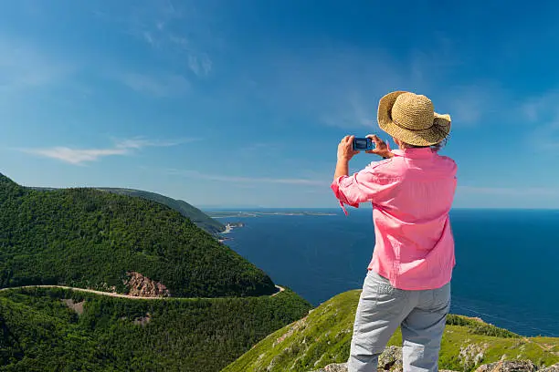 Photo of Woman photographing landscape, Skyline, Cabot trail, Cape Breton, Nova Scotia