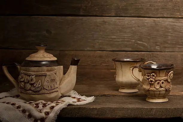 The photo shows the different utensils for tea and other hot drinks. In the background serve as a wooden tableThe photo shows the different utensils for tea and other hot drinks. In the background serve as a wooden table