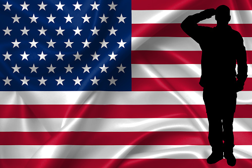 Silhouette of American (USA) soldier saluting to USA flag