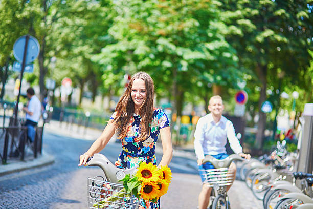istock Young romantic couple using bicycles in Paris, France 509315438