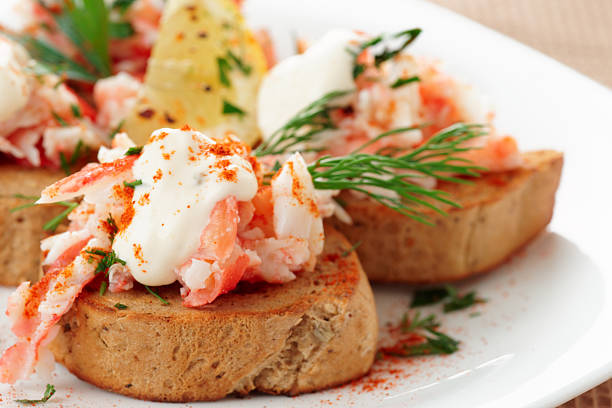 Crab meat with toast, sauce and fresh herbs, close-up