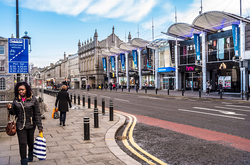 Aberdeen, United Kingdom - February 10, 2016:  Shoppers on Union Street, Aberdeen, Scotland, with the Trinity Shopping Centre opposite. Long and straight, all major routes to other cities connect to the ends of Union Street. The Trinity Centre hosts many of the best known high street retail outlets in the UK.