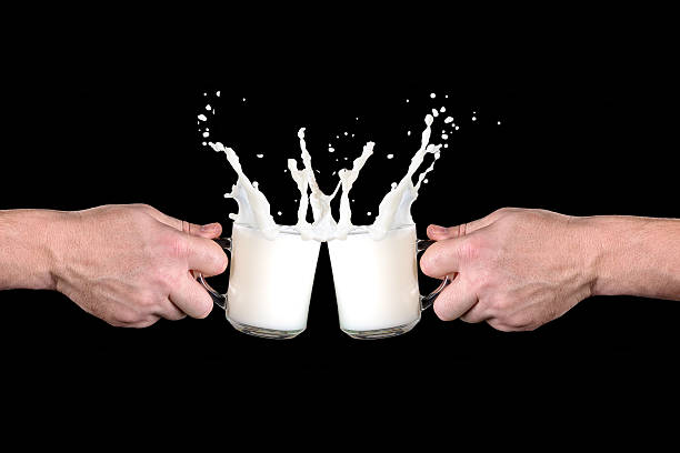 istock two cups with milk strike against each other 509318096