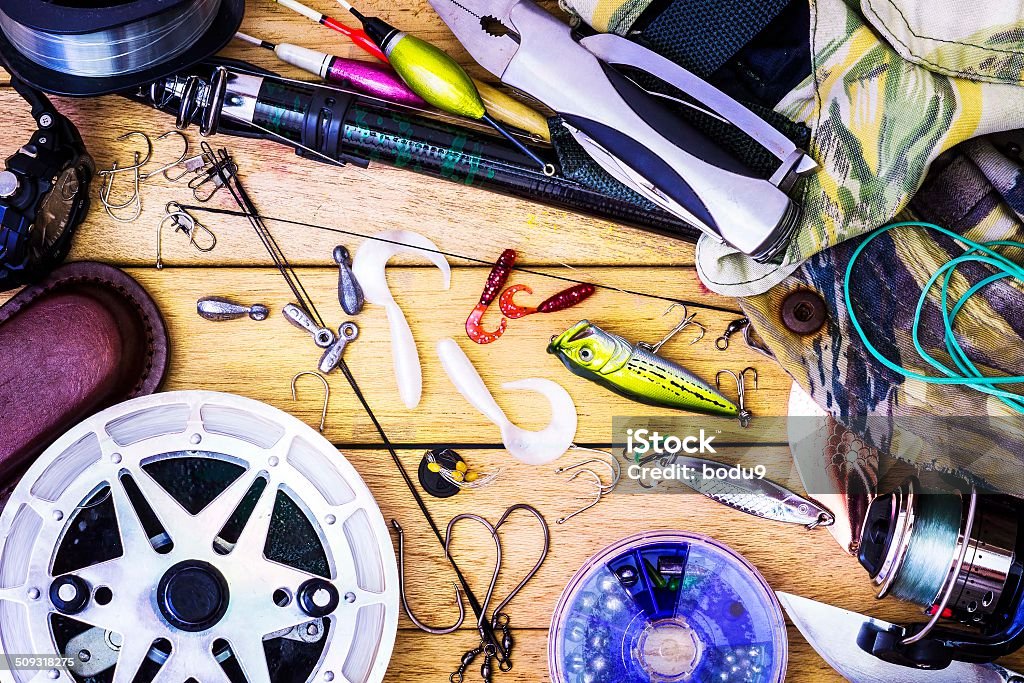 Fishing gear on the table as a frame Fishing tackle on a table in a frame, the theme hobby sport Activity Stock Photo