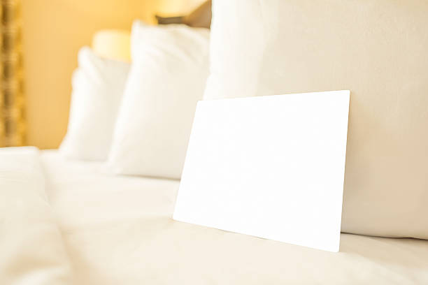 istock Closeup of hotel bed with blank card 509318769