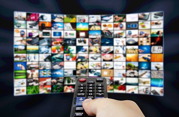 istock Big LCD panel with television stream images and remonte control 509319111
