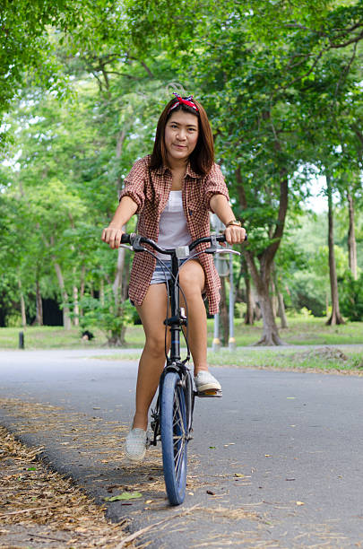 istock women with bicycle in nature field 509320865